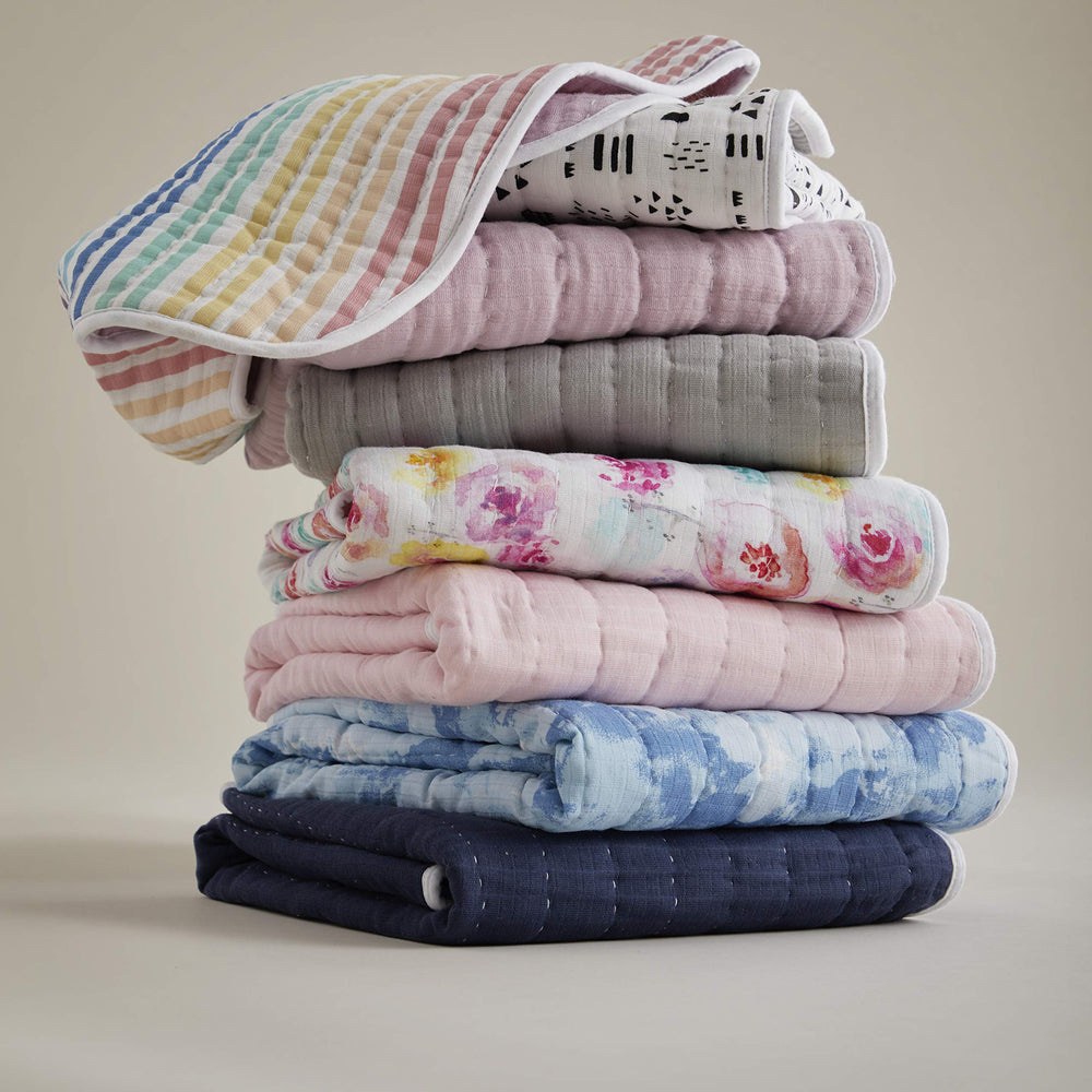 HonestBaby blanket draped over a nursery chair for chic decor styling