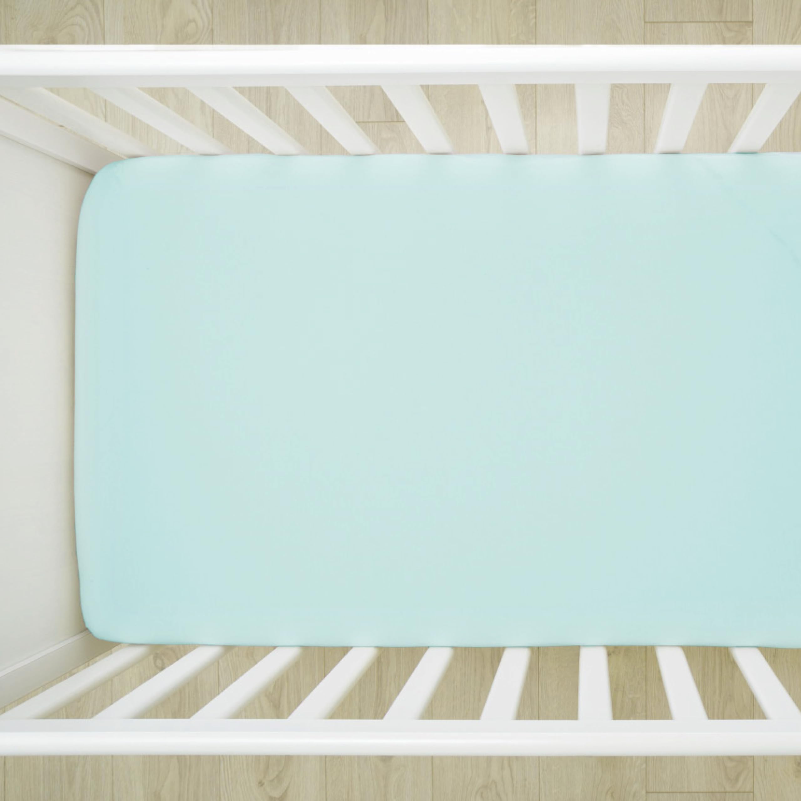 HonestBaby sage crib sheet elastic edge emphasizes snug, stay-put fit during night feedings.