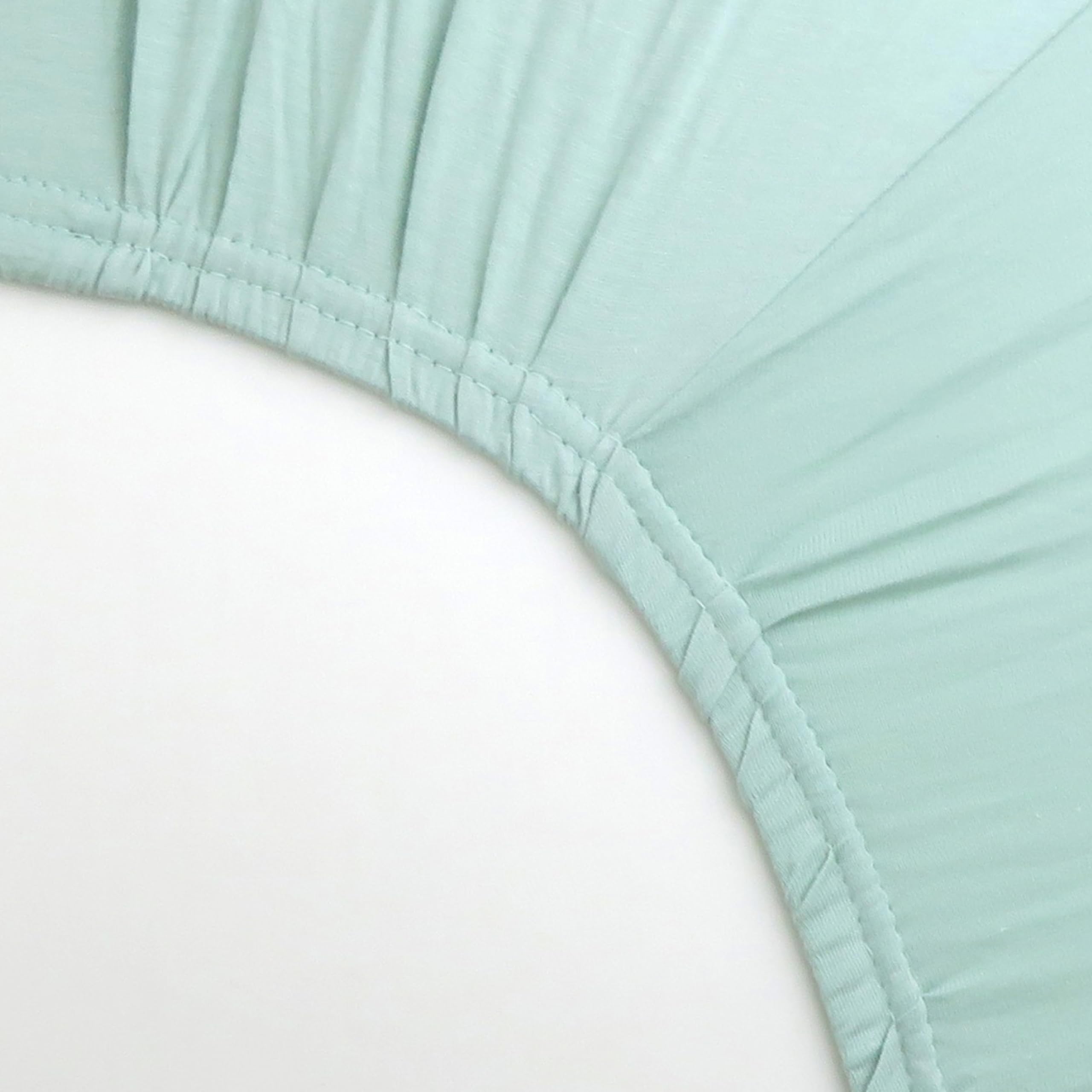 HonestBaby sage crib sheet on standard mattress demonstrates easy care and longevity.