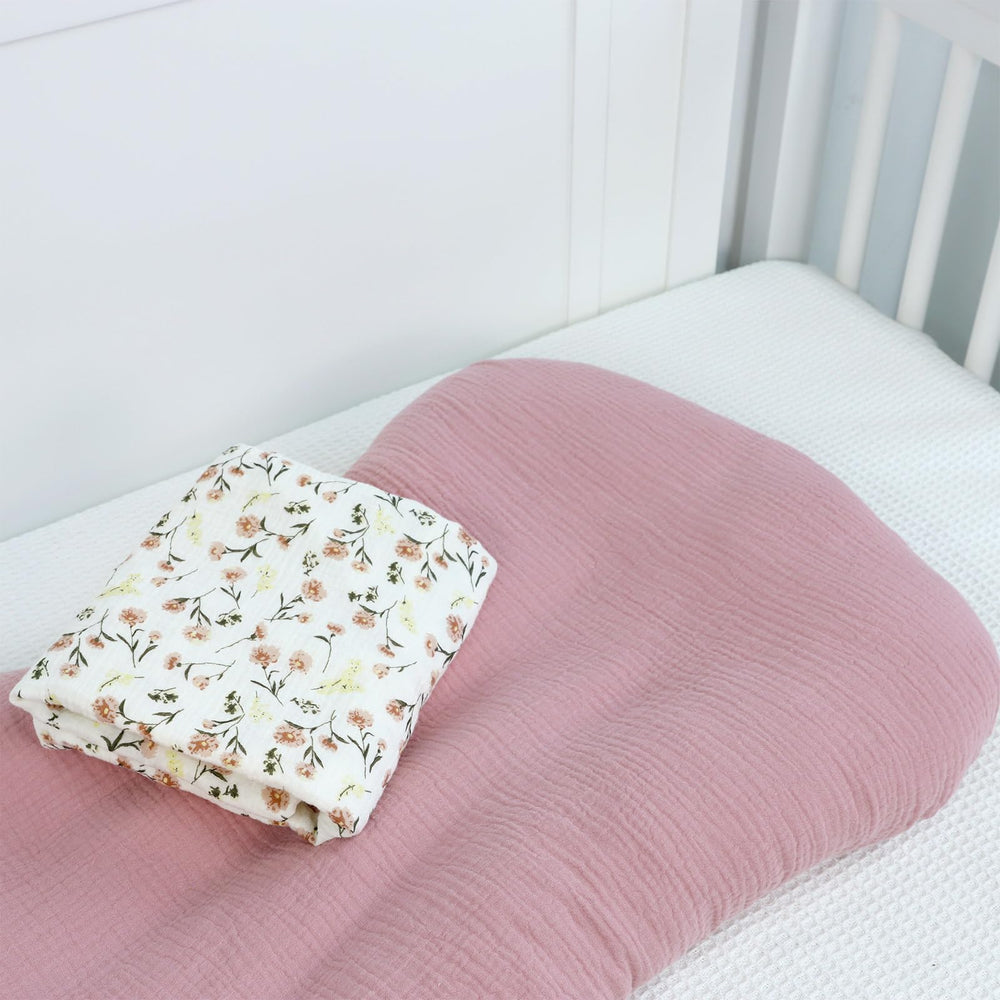 Flesh pink and floral design adds a soft nursery touch.