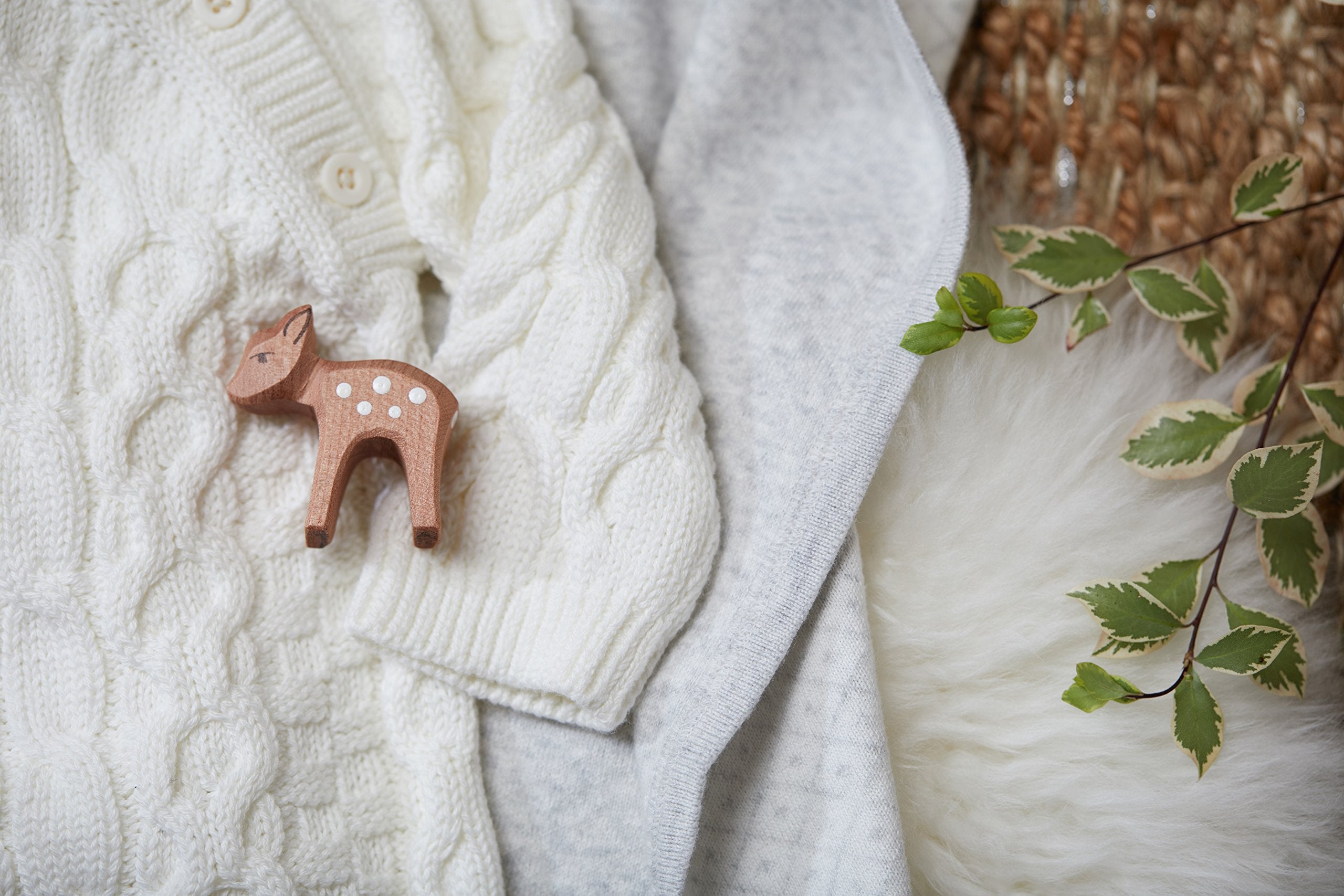 Hope & Henry Baby Jacquard Sweater Blanket on bedside keeps baby snug.