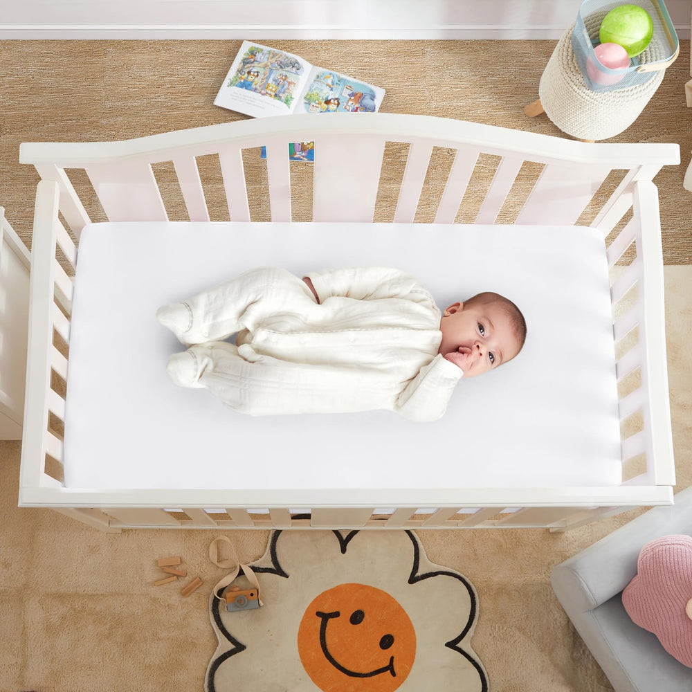 Horbaunal satin pack n play sheet placed on baby mattress for easy setup.