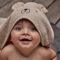 Huxie hooded towel on hanging display in bear fog color, showing soft texture.