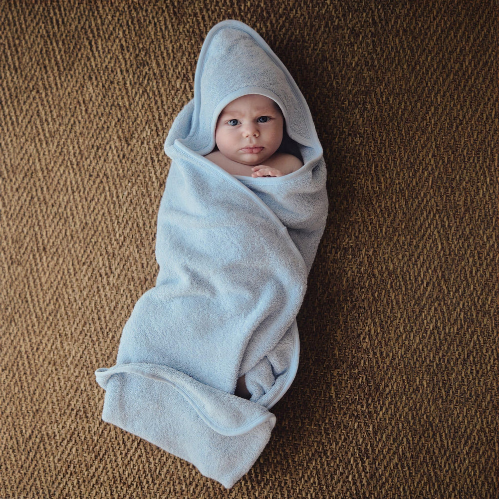 Close-up of Huxie hooded towel fabric, soft organic cotton for absorbent bath time.