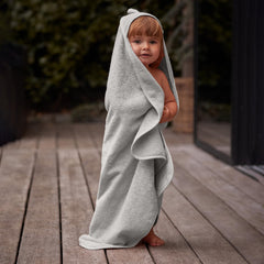Huxie baby wrapped in towel after bath, snug and secure