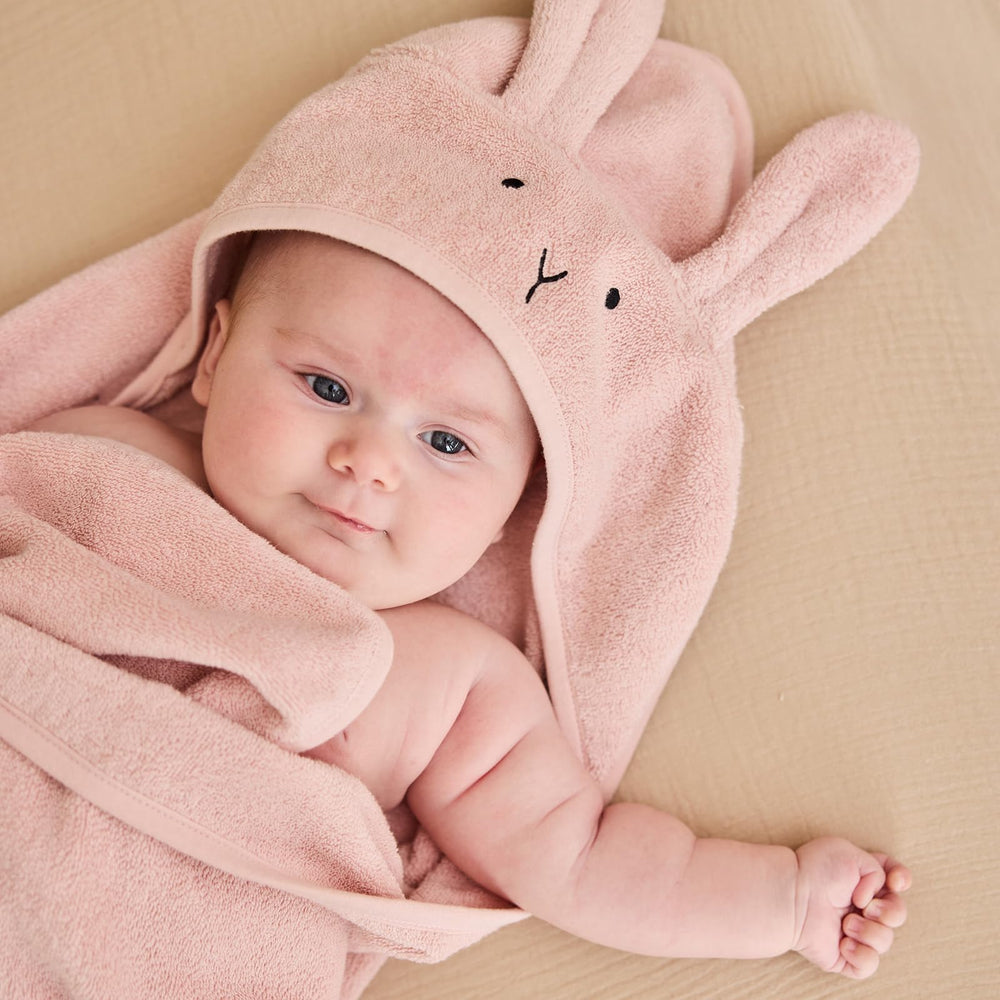 Huxie hooded towel on baby during bath time for quick drying.
