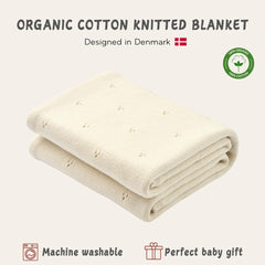 Huxie blanket in baby's arms, ivory, cozy cuddles for nap time.