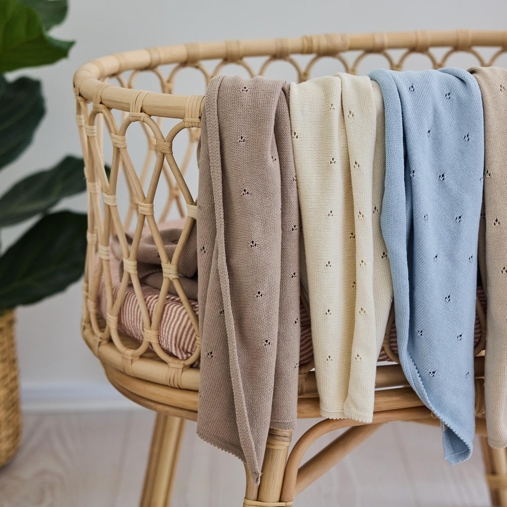 Huxie blanket used as a light baby shawl, all-season comfort.