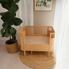 Close-up of organic cotton fiber texture on Huxie crib sheet.