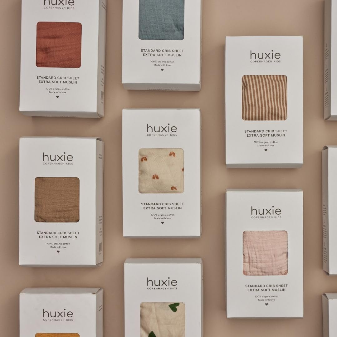 Huxie cedar sheet beside a calm nursery setting for gift-ready presentation