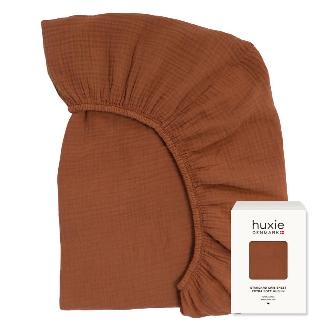 Huxie crib sheet close-up showing organic cotton muslin texture for ultra-soft comfort