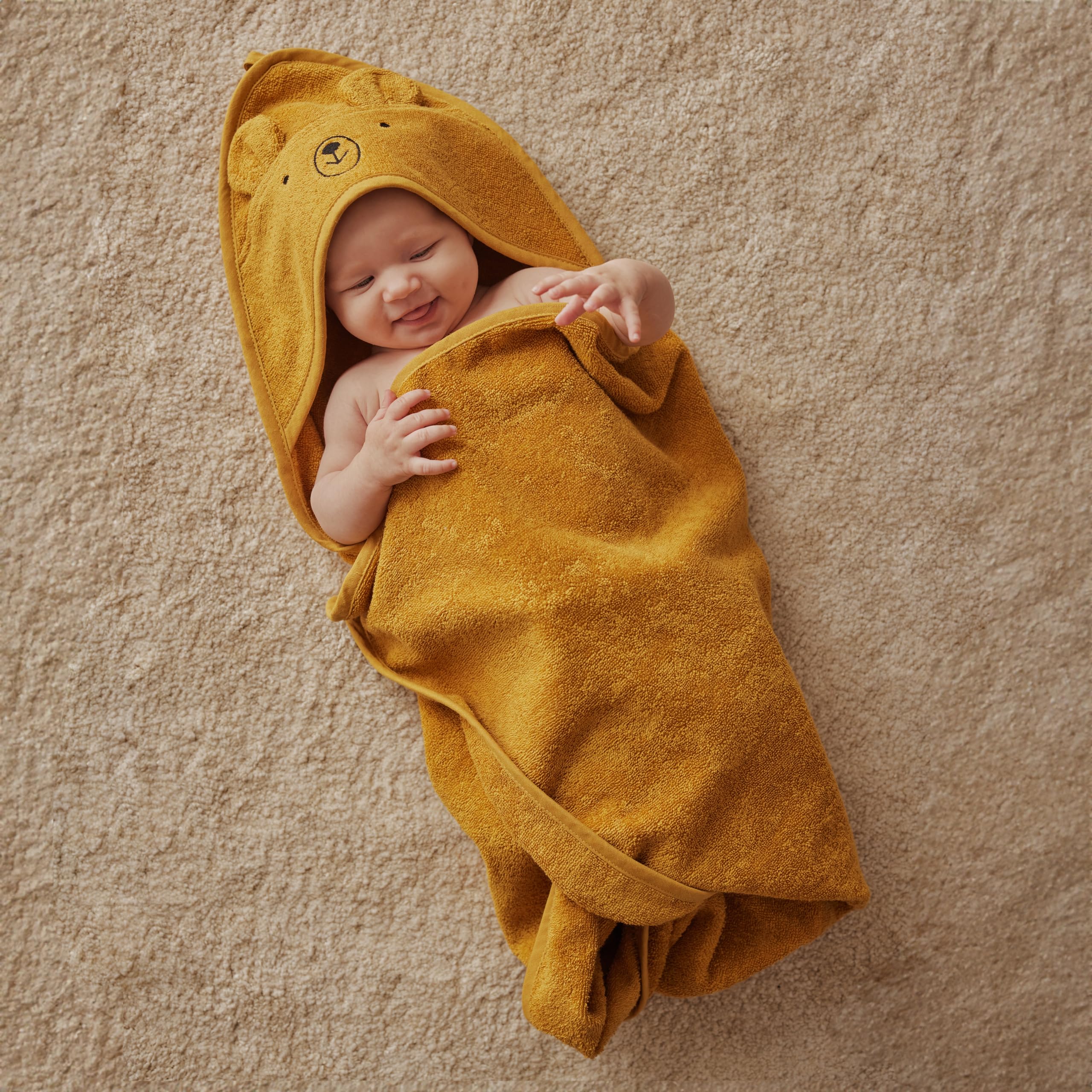 Huxie hooded towel after bath keeps little one warm and dry.