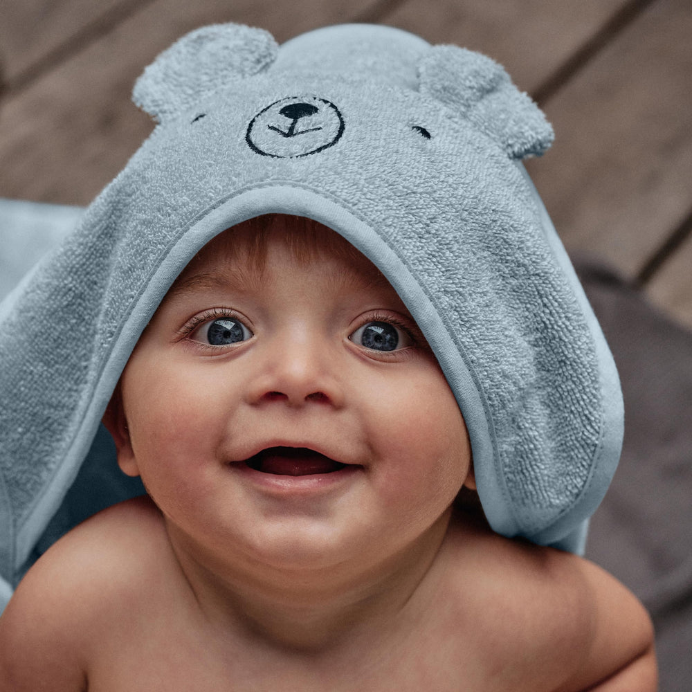 Huxie hooded towel Bear Baby Blue hood demonstrates cozy warmth after bath.