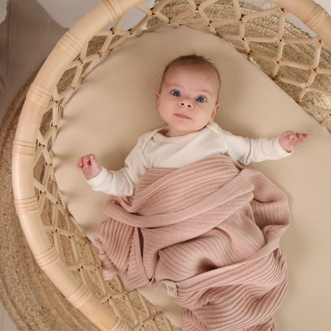 Huxie knitted baby blanket blush front view highlights gentle snuggle time.