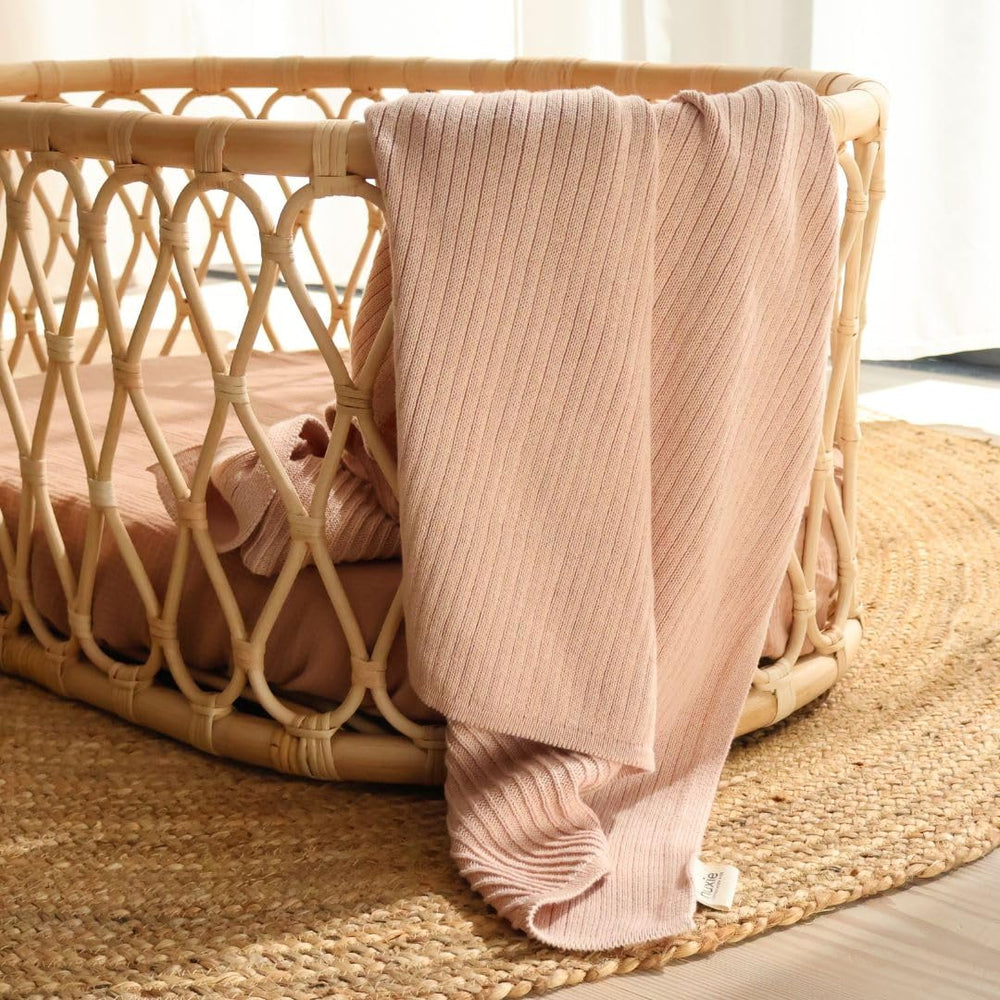 Huxie blanket in crib-time setting offering breathable warmth for cozy naps.