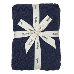 Huxie knitted baby blanket in organic cotton, exceptionally soft for newborn snuggles.
