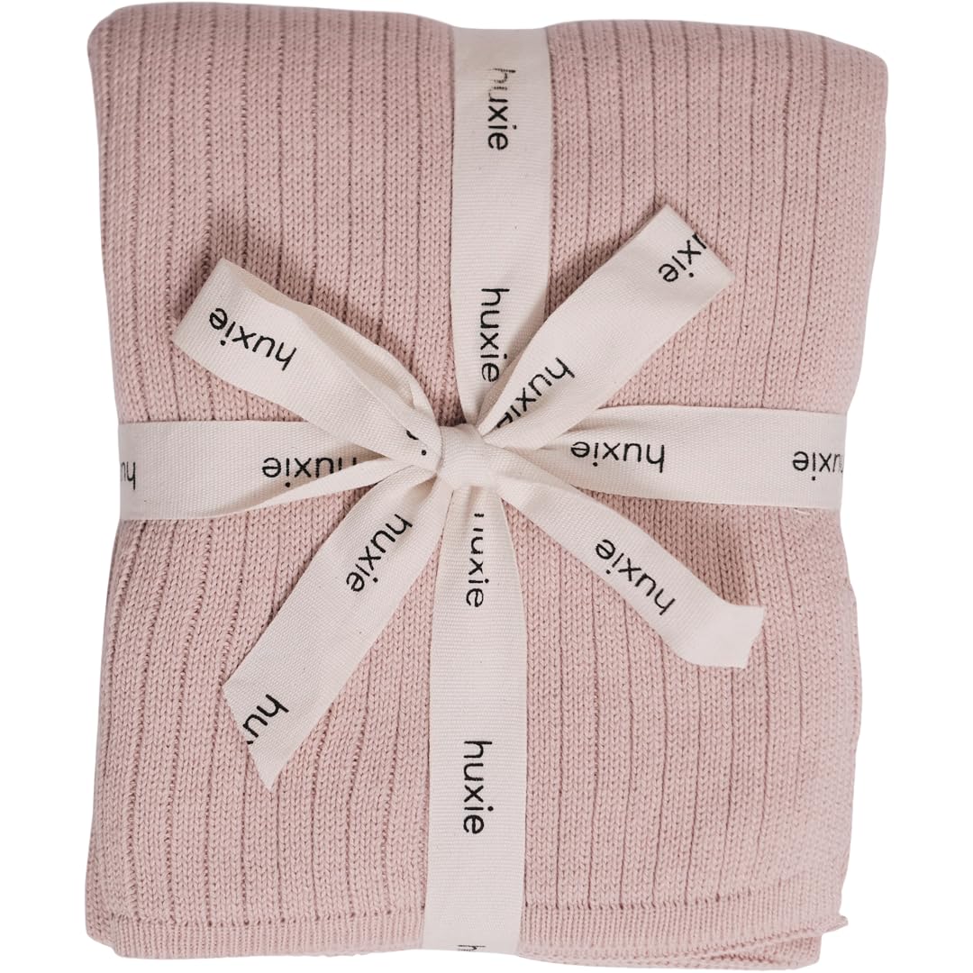 Huxie knitted baby blanket ribbed blush closeup showing soft texture for delicate skin.