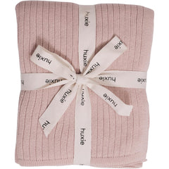 Huxie knitted baby blanket ribbed blush closeup showing soft texture for delicate skin.
