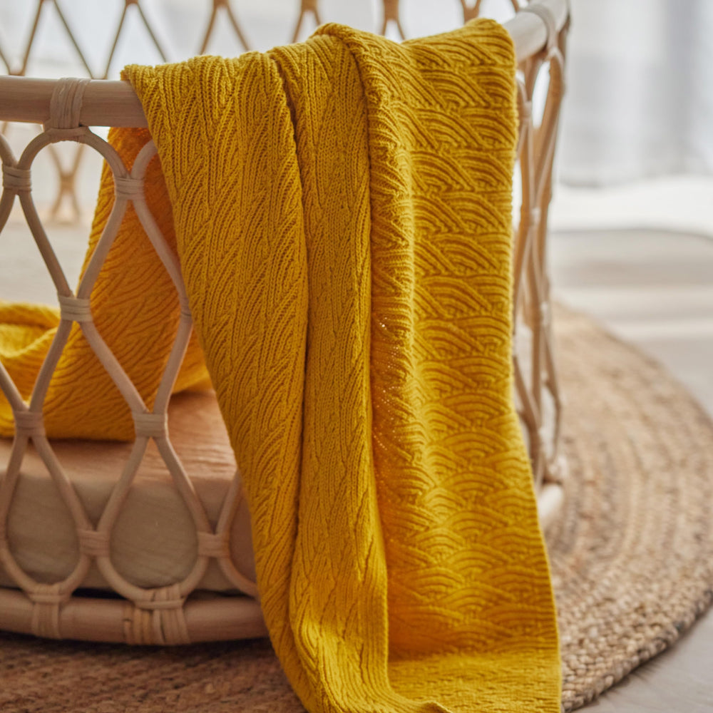 Huxie Waves-Yellow blanket used with toddlers, durable through growth.
