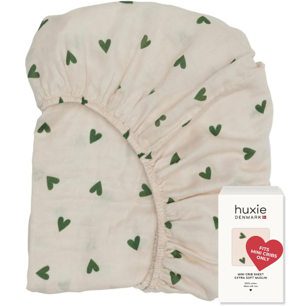 Huxie mini crib sheet in soft muslin close-up for gentle skin comfort.