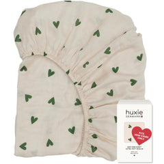 Huxie mini crib sheet in soft muslin close-up for gentle skin comfort.