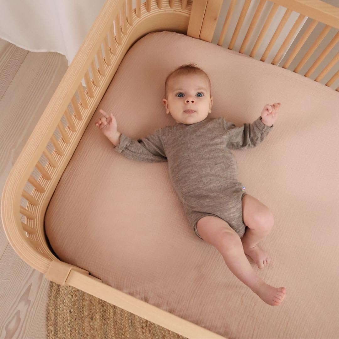 Close-up of Huxie organic cotton muslin texture showing softness.