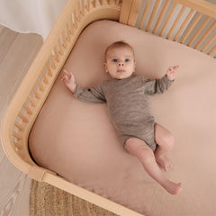 Close-up of Huxie organic cotton muslin texture showing softness.
