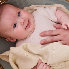 Huxie pointelle knit close-up in ivory showing breathable weave for all-season comfort.