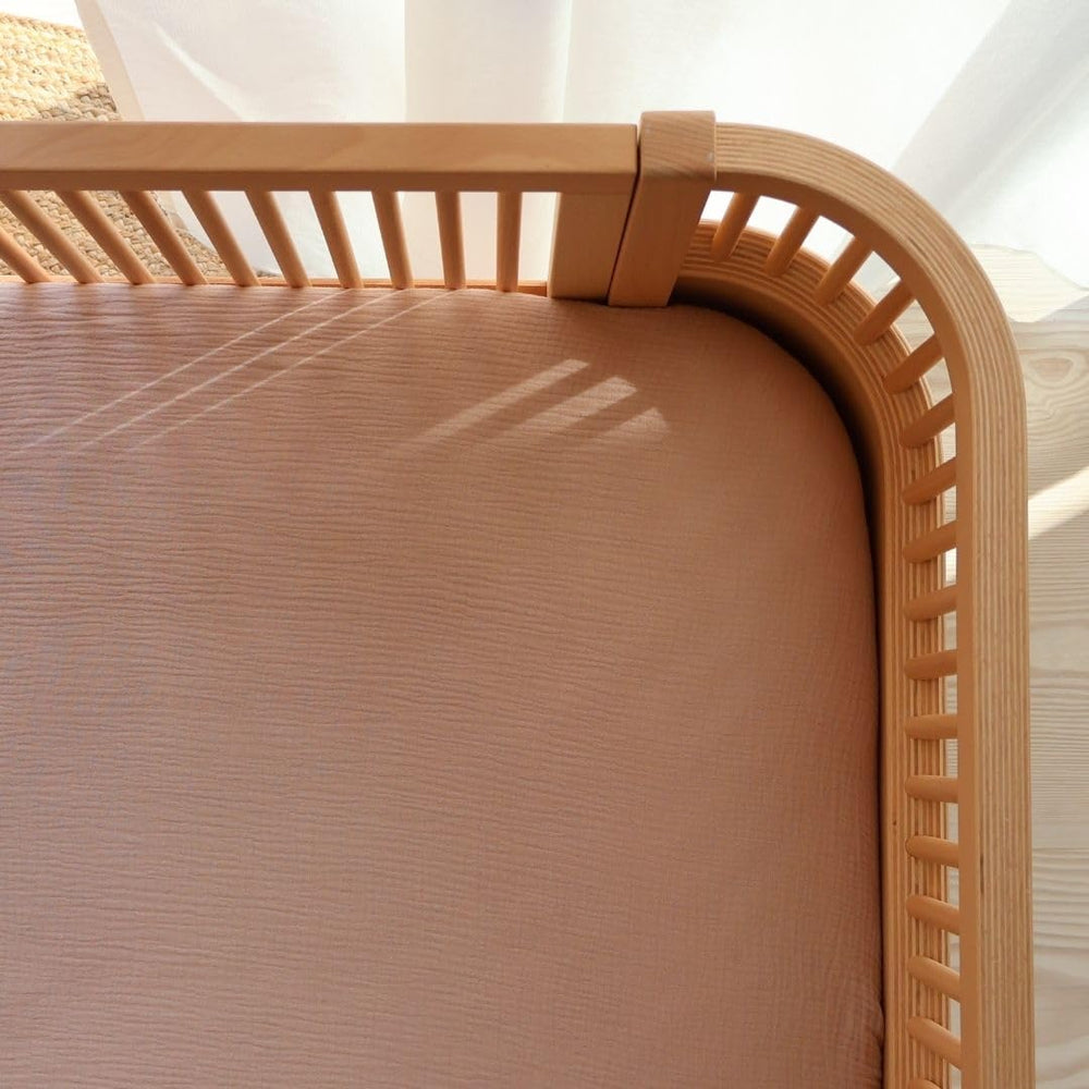 Secure 24x38 fit ensures stable placement on mini cribs.