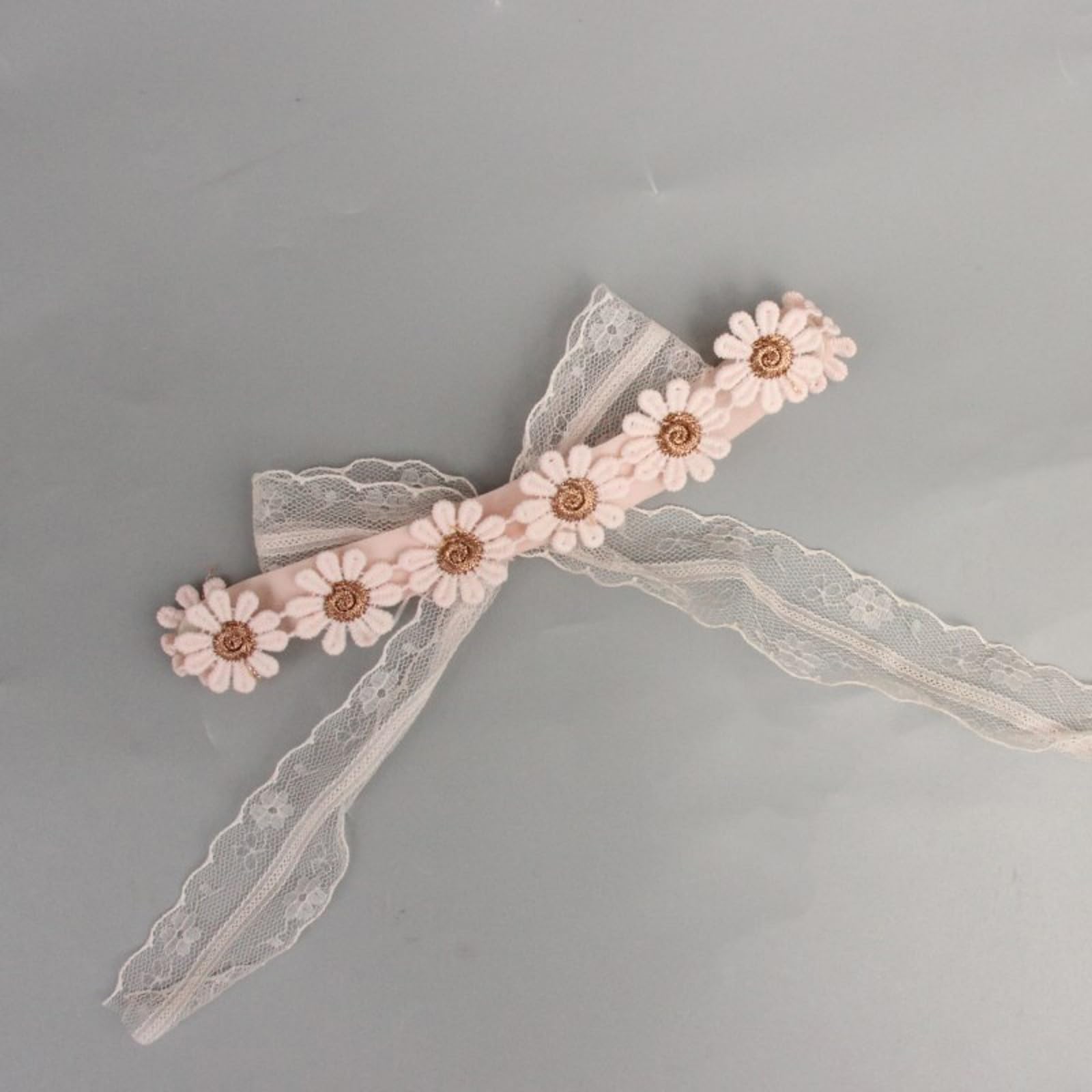 ICKEYOU lace headband closeup pink with daisy accent, soft elastic fit for newborns and toddlers.
