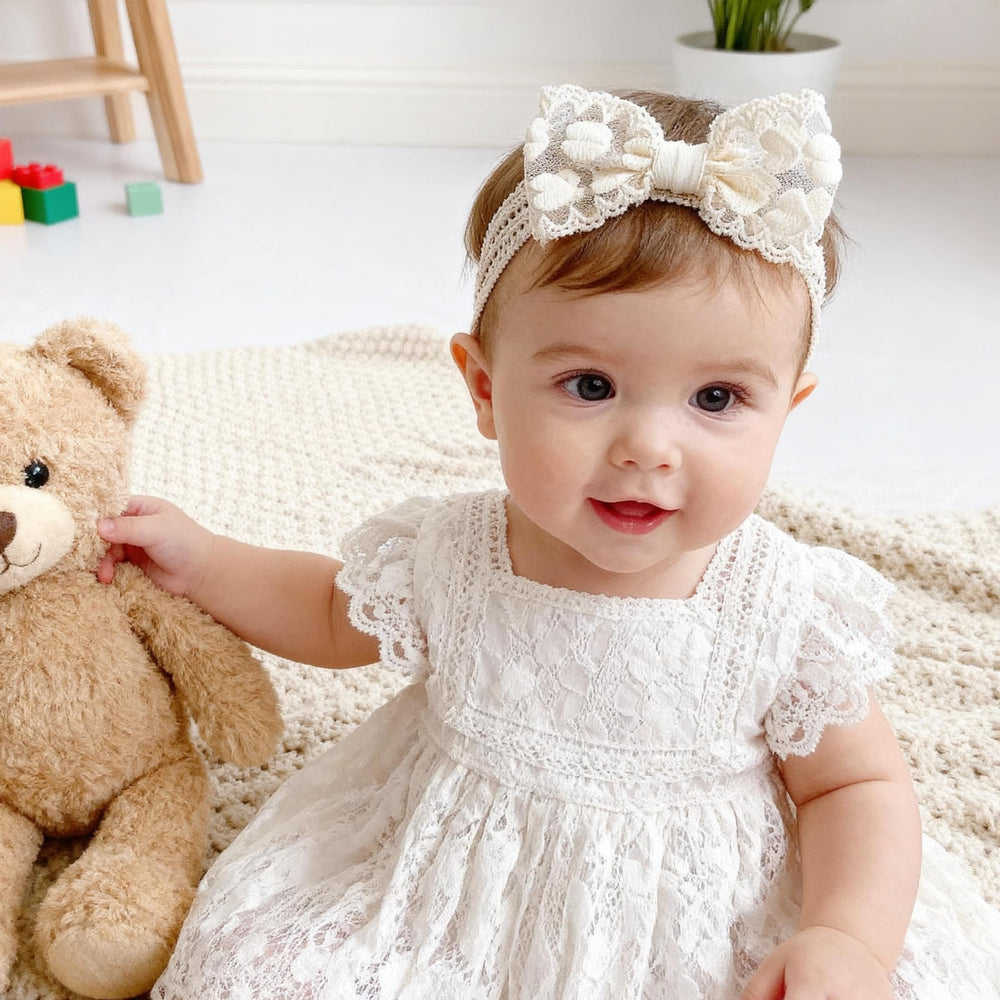 icke-you floral lace bow headband; charming accessory for christenings and birthdays.