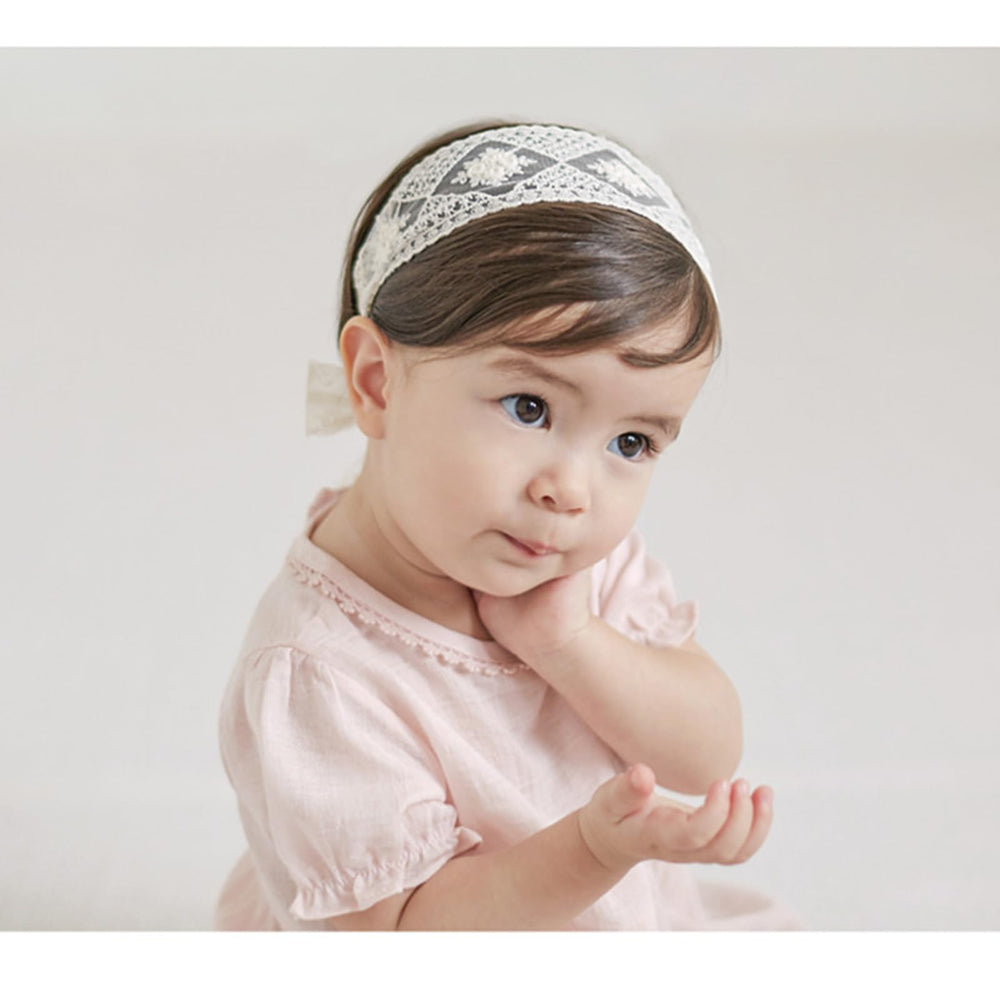 ICKEYOU elastic floral-detail headband keeps a secure, gentle fit during play.