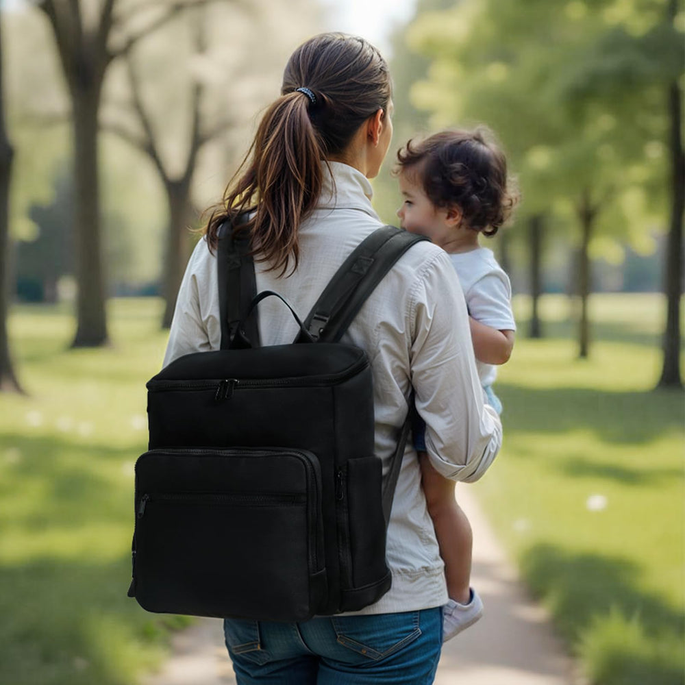 ILCOLPO diaper bag backpack open wide, showcasing 16 pockets for easy packing.