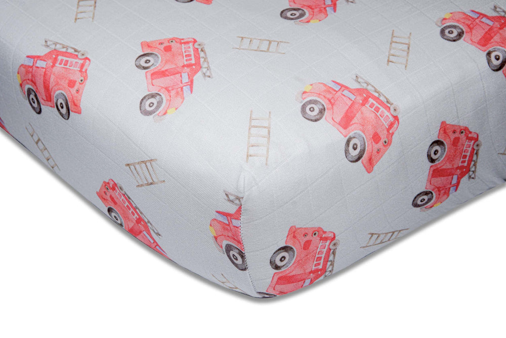 Immispace fire truck crib sheet on a standard crib for newborn comfort.