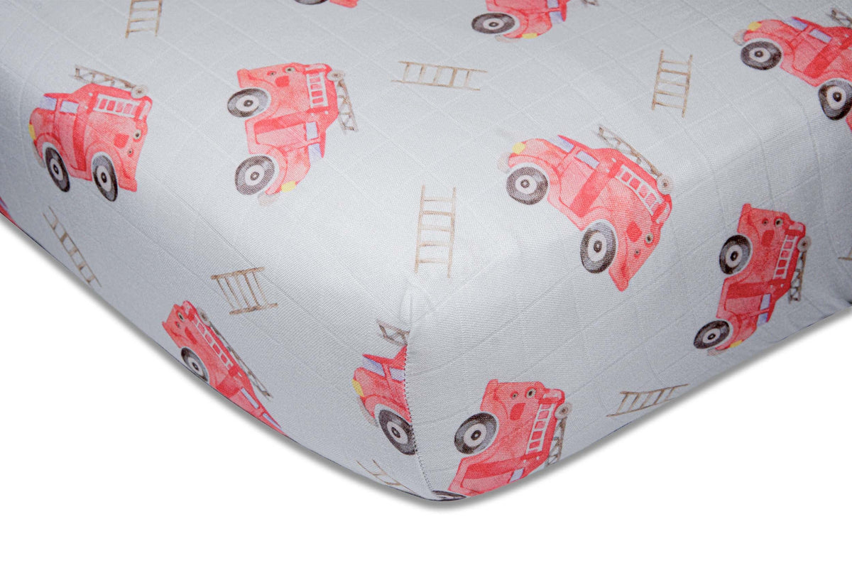 Immispace fire truck crib sheet on a standard crib for newborn comfort.