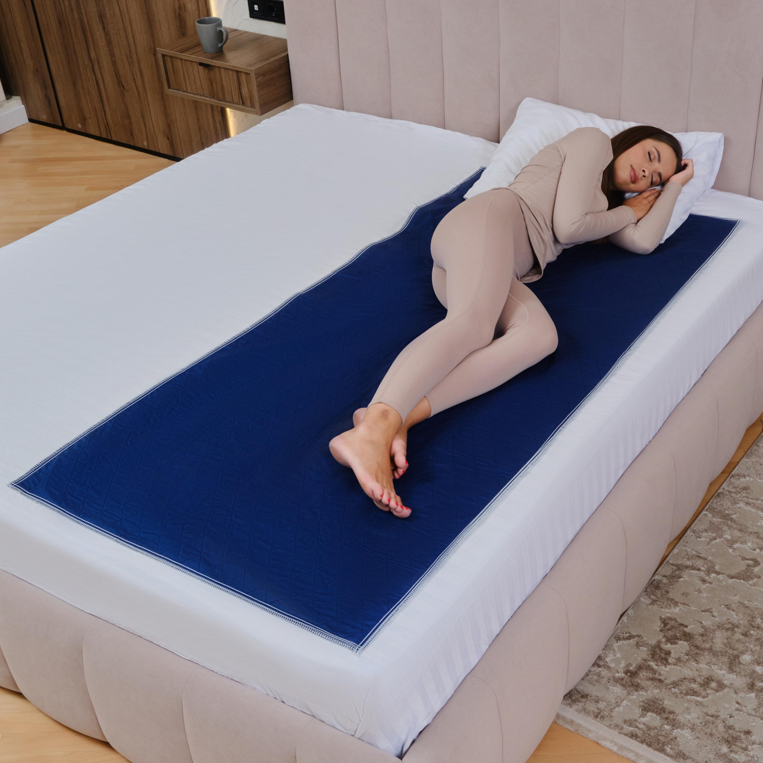 Inspire Waterproof Mattress Pad in dark navy protects the bed from spills and stains.