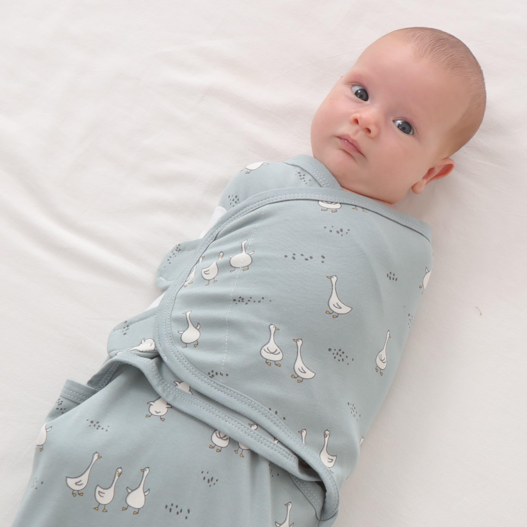 Insular Baby Swaddle Wrap Beige Swan three designs on display for variety