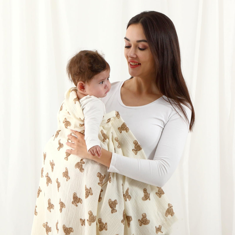 Insular muslin swaddle khaki-color 47x47 complements nursery decor.