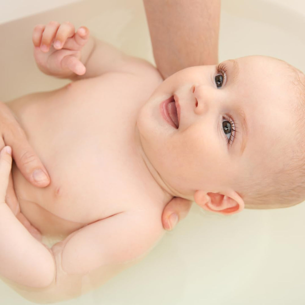 Irene Organics Oatmeal Bath Powder in tub scene, suitable for baby and toddler skin.