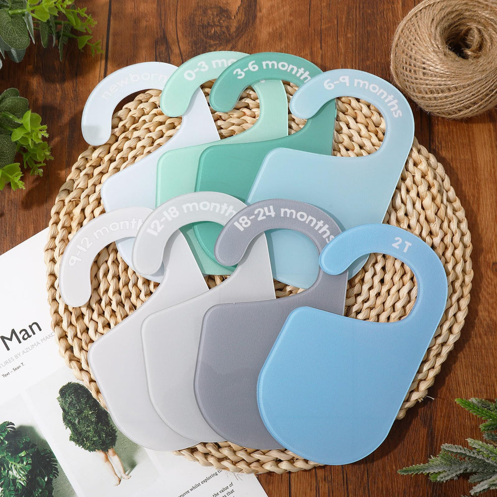 JarThenaAMCS acrylic baby closet divider hanging on closet rod for quick age labeling.