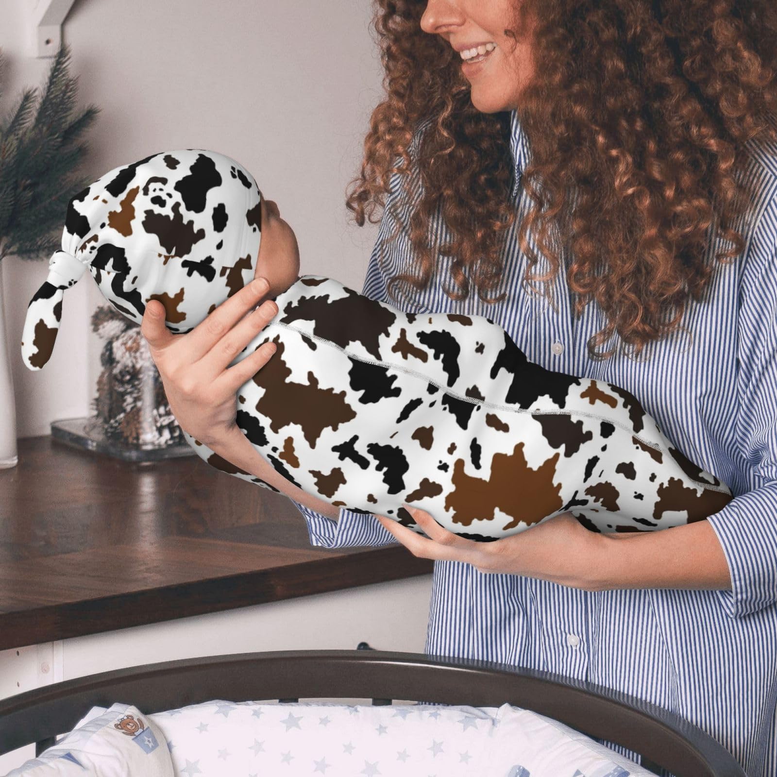 Jarverce cow-print hat paired with swaddle for newborn outfits.