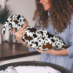 Jarverce cow-print hat paired with swaddle for newborn outfits.