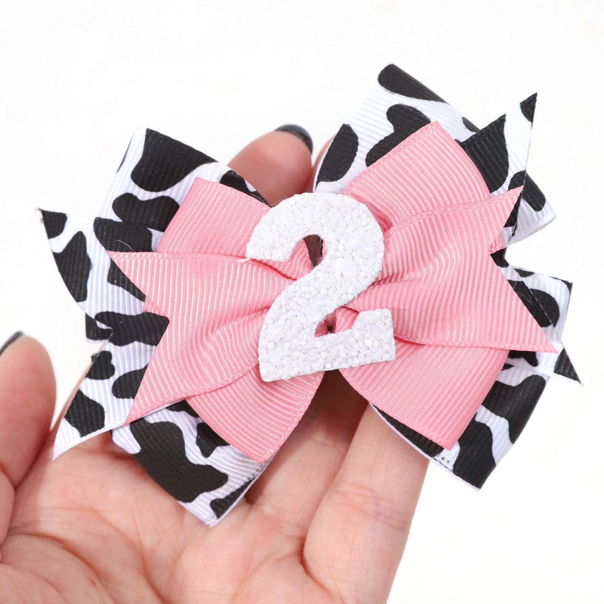 Jissoo cow print bow headband pink front view ideal for baby photos