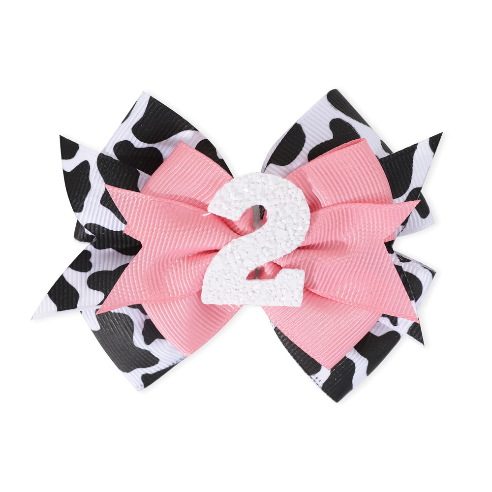 Jissoo cow print bow headband pink worn with various outfits