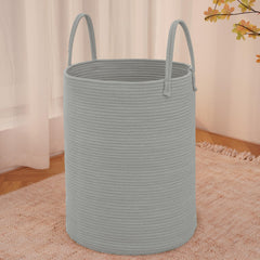 JMvicyroam large woven laundry basket in grey holding blankets and clothes.