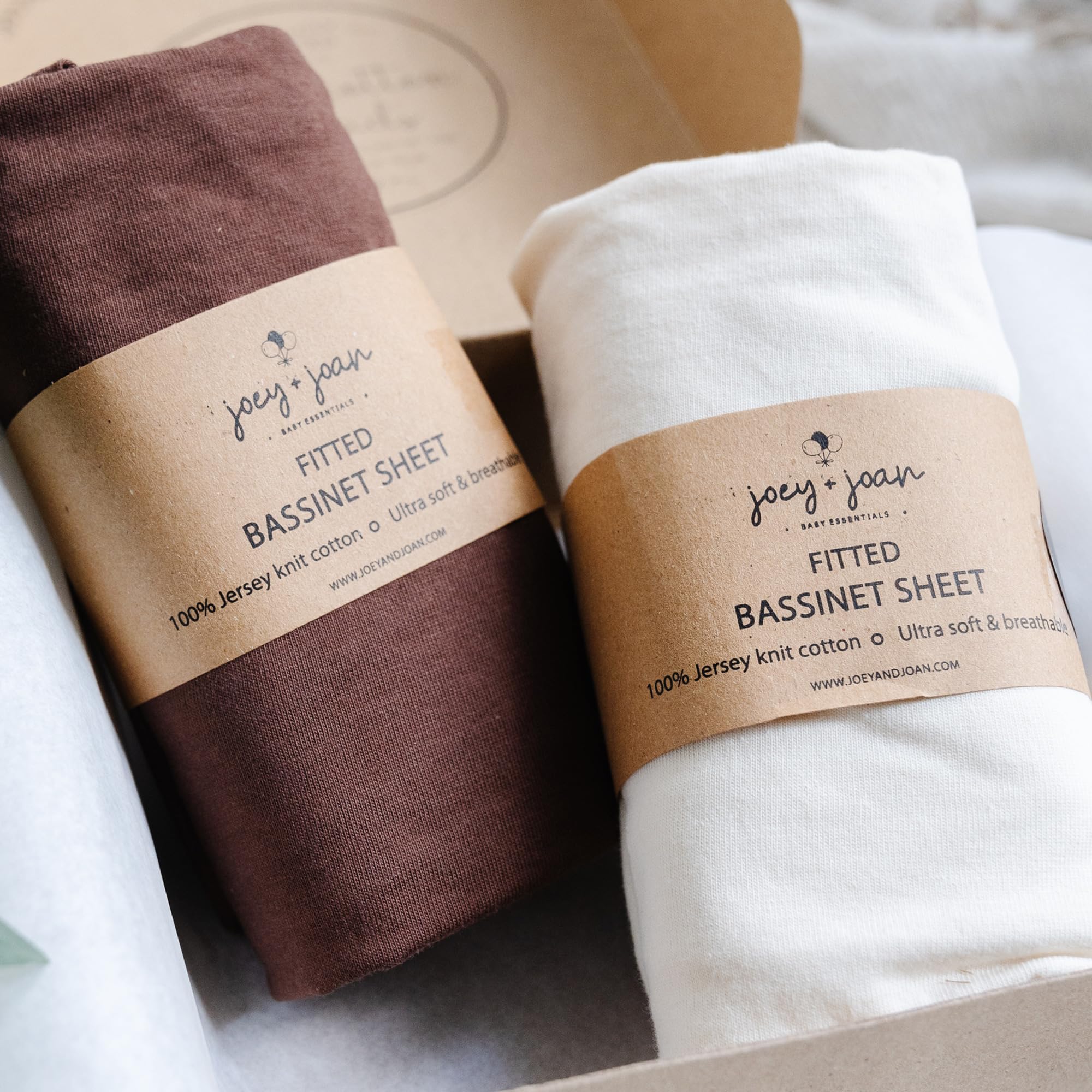 Joey + Joan 2-pack bassinet sheets in cream and brown packaging for easy changes