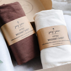 Joey + Joan 2-pack bassinet sheets in cream and brown packaging for easy changes