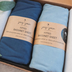 Joey + Joan bassinet sheets close-up shows jersey cotton softness for gentle sleep.