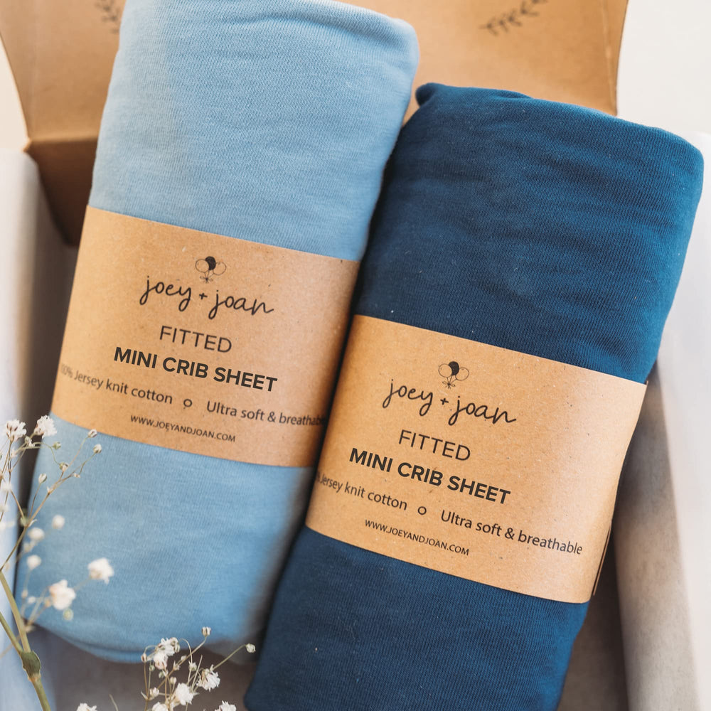 Joey + Joan 2-pack mini crib sheets showcase soft fabric and cozy color options