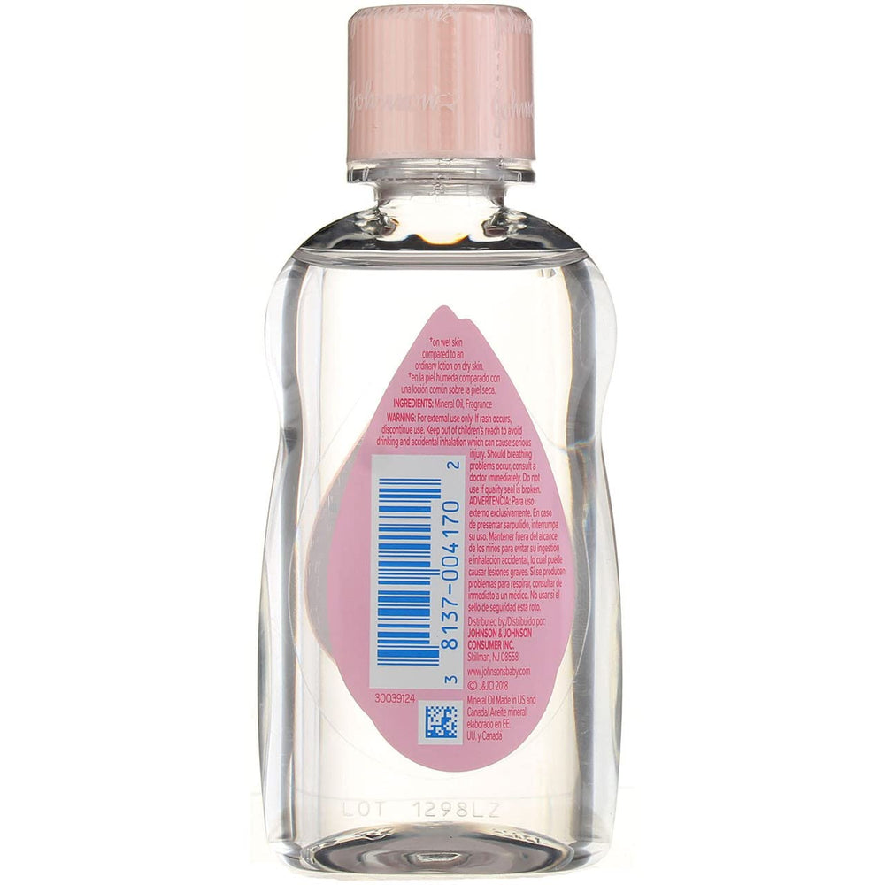 Applying Johnson & Johnson Baby Oil to a baby's skin for moisture.